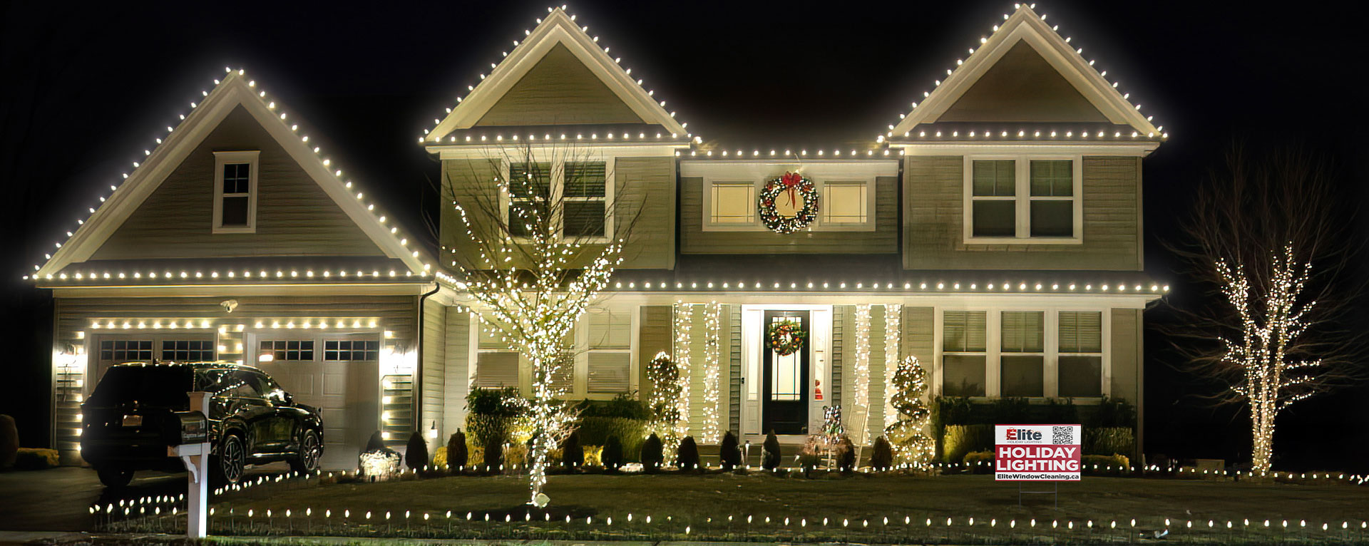 Warm white holiday lights along a home roofline