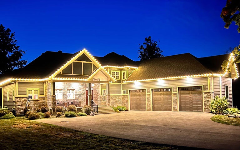 Suburban home with elegant warm white roofline holiday lights